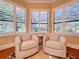 Cozy living area featuring plush armchairs and plantation shutters offering plenty of natural light at 38207 Sabal Way, Umatilla, FL 32784