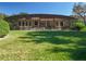 View of the screened-in pool and lush green lawn offering relaxation and privacy at 38207 Sabal Way, Umatilla, FL 32784