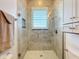 Shower with a glass door, neutral tiling, and a built-in nook at 38207 Sabal Way, Umatilla, FL 32784