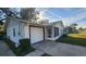 White single-story house with a garage and screened porch at 436 Avenue G Se, Winter Haven, FL 33880