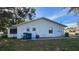 Rear view of the house showing a side entrance and utility area at 436 Avenue G Se, Winter Haven, FL 33880