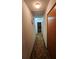 Long hallway with carpeted floor leading to bedrooms at 436 Avenue G Se, Winter Haven, FL 33880