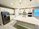 Modern kitchen with white cabinets and large island at 4476 Lions Gate Ave, Clermont, FL 34711