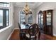 Formal dining room with hardwood floors, a large table, and a display cabinet at 4500 Stone Hedge Dr, Orlando, FL 32817