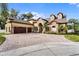 Two-story house with stone accents, a three-car garage, and a paved driveway at 4500 Stone Hedge Dr, Orlando, FL 32817