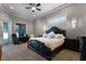 Main bedroom with plush carpet, large bed and sitting area at 4500 Stone Hedge Dr, Orlando, FL 32817