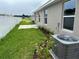 Small backyard with grass, patio, and AC unit at 4586 Se 25Th Loop, Ocala, FL 34480