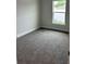 Spacious bedroom with grey carpet and a window at 4586 Se 25Th Loop, Ocala, FL 34480