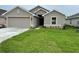 Newly built home with a two-car garage and a neatly landscaped lawn at 4586 Se 25Th Loop, Ocala, FL 34480