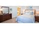 Cozy bedroom with light blue bedding and ample closet space at 4940 Lyric Dr, Mascotte, FL 34753