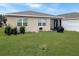 Back yard with green lawn and a grill with privacy fence at 5093 Meadow Song Dr, Okahumpka, FL 34762