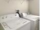 White, standard size washer and dryer located in a laundry area at 5093 Meadow Song Dr, Okahumpka, FL 34762