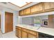 Kitchen with wood cabinets, tile floor, and stainless steel appliances at 5132 Lazy Oaks Dr # 5132, Winter Park, FL 32792