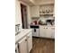 White kitchen cabinets, wood floors, and appliances at 516 Orange Dr # 26, Altamonte Springs, FL 32701