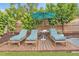 Wooden deck with lounge chairs and small side table at 528 Broadway Ave, Orlando, FL 32803