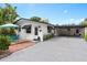 Cute bungalow with carport, patio furniture, and well-manicured landscaping at 528 Broadway Ave, Orlando, FL 32803