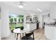 Modern eat-in kitchen with white cabinets, granite counters and a view of the backyard at 528 Broadway Ave, Orlando, FL 32803