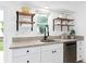 Bright kitchen with white cabinets, granite countertops, and a farmhouse sink at 528 Broadway Ave, Orlando, FL 32803