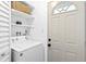 Laundry room with washer, dryer, and storage shelves at 528 Broadway Ave, Orlando, FL 32803