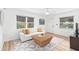 Light and airy living room with white couch and wicker coffee table at 528 Broadway Ave, Orlando, FL 32803