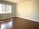 Bright bedroom with wood-look floors and large window at 5429 Vineland Rd # S, Orlando, FL 32811