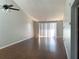 Living room with wood-look floors and sliding glass door at 5429 Vineland Rd # S, Orlando, FL 32811