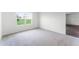 Bright bedroom with grey carpet and view to backyard at 5489 Hayloft Dr, Apopka, FL 32712