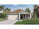 One-story home with light blue siding, white garage door, and landscaping at 5489 Hayloft Dr, Apopka, FL 32712