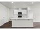 Modern kitchen with white cabinets and quartz island at 5489 Hayloft Dr, Apopka, FL 32712