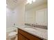 Bathroom with single vanity, granite countertop, and bathtub at 5650 Wooden Pine Dr, Orlando, FL 32829