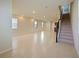 Open living room with tile floors and staircase at 5650 Wooden Pine Dr, Orlando, FL 32829