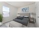 Main bedroom with gray bedding, bench at foot of bed, and large window at 5839 Galloping Dr, Apopka, FL 32712