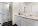 Bathroom with double vanity, white cabinets, and shower/tub at 5871 Galloping Dr, Apopka, FL 32712