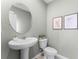 Small powder room with pedestal sink and round mirror at 6022 Galloping Dr, Apopka, FL 32712