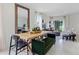 Dining area with wood table, green bench, and large mirror at 6022 Galloping Dr, Apopka, FL 32712