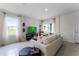 Living Room with light beige sofa and sliding glass doors to patio at 6022 Galloping Dr, Apopka, FL 32712