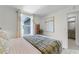 Well-lit bedroom with window and adjacent bathroom at 6034 Galloping Dr, Apopka, FL 32712