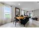 Open concept dining area with a wooden table and green bench seating at 6034 Galloping Dr, Apopka, FL 32712