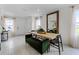 Bright dining area with a wooden table and green velvet bench at 6034 Galloping Dr, Apopka, FL 32712