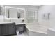 Bathroom with a vanity, soaking tub, and a glass block window at 623 Yorkshire Dr, Oviedo, FL 32765