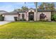 One-story house with a gray roof and lush green lawn at 623 Yorkshire Dr, Oviedo, FL 32765