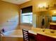 Bathroom with corner bathtub, double vanity, and separate shower at 6879 Remington View Ct, Orlando, FL 32829