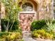 Inviting entryway with double doors, lush landscaping, and a charming wreath at 6879 Remington View Ct, Orlando, FL 32829