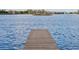 Serene view of the lake from a wooden dock at 6879 Remington View Ct, Orlando, FL 32829