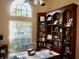 Home office with built-in bookshelves and large window at 6879 Remington View Ct, Orlando, FL 32829