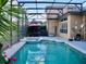 Inviting screened pool with spa and patio furniture at 6879 Remington View Ct, Orlando, FL 32829