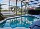 Screened pool and spa overlooking a lake at 6879 Remington View Ct, Orlando, FL 32829