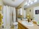 Bathroom with shower/tub combo, white vanity, and gold accents at 6928 Sw 152Nd St, Ocala, FL 34473