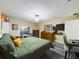 Bedroom with green bedding, a dresser, and a laptop workspace at 6928 Sw 152Nd St, Ocala, FL 34473