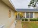 House entrance with walkway, landscaping, and a decorative door at 6928 Sw 152Nd St, Ocala, FL 34473